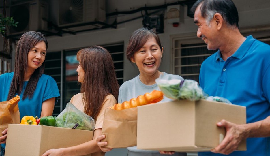 Four people at a food distribution event